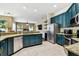 Modern kitchen with granite countertops, stainless steel appliances, and teal-colored cabinetry at 2009 Raven Manor Dr, Dover, FL 33527