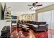 Cozy living room with dark wood floors and large sectional sofa with an open concept layout at 2009 Raven Manor Dr, Dover, FL 33527