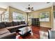 Spacious living room with natural light, hardwood floors, and a comfortable seating area at 2009 Raven Manor Dr, Dover, FL 33527