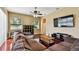 Cozy living room with natural light, hardwood floors, and a large sectional sofa at 2009 Raven Manor Dr, Dover, FL 33527