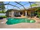 The backyard features an inviting pool, covered lanai, mature landscaping and a privacy fence at 2009 Raven Manor Dr, Dover, FL 33527