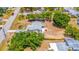 Aerial view of residence featuring a long driveway with carport, screened-in porch, and small backyard patio at 208 Palmetto W Rd, Nokomis, FL 34275