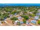 An aerial view showcases the property's desirable location near lush green trees and blue waterways at 208 Palmetto W Rd, Nokomis, FL 34275