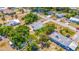 Aerial shot of the property highlighting its proximity to mature trees and neighborhood features at 208 Palmetto W Rd, Nokomis, FL 34275