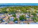 Lovely aerial view of a single Gathering home, embraced by verdant trees, near sparkling coastal waters and city view at 208 Palmetto W Rd, Nokomis, FL 34275