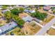 Aerial view of the home and neighborhood with a large driveway and tree shaded yard at 208 Palmetto W Rd, Nokomis, FL 34275