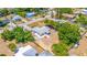 Aerial view showcases a residence featuring a long driveway with carport, screened-in porch, and hot tub patio area at 208 Palmetto W Rd, Nokomis, FL 34275