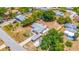 An aerial view showcases a well-kept residence featuring a long driveway with carport in a quiet neighborhood at 208 Palmetto W Rd, Nokomis, FL 34275
