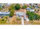 An aerial view of a well-kept residence featuring a long driveway with carport and privacy fence in a quiet neighborhood at 208 Palmetto W Rd, Nokomis, FL 34275