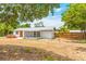 Spacious backyard featuring a well-maintained lawn, a hot tub, and the rear exterior of the charming single-story home at 208 Palmetto W Rd, Nokomis, FL 34275