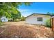 Spacious backyard with lush trees and a storage shed offers a private outdoor space at 208 Palmetto W Rd, Nokomis, FL 34275