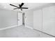 Bright bedroom with new white marble-look tile flooring, fan, and closet at 208 Palmetto W Rd, Nokomis, FL 34275