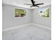 Light and airy bedroom with large windows and marble-look tile flooring at 208 Palmetto W Rd, Nokomis, FL 34275