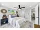 Inviting bedroom with a comfortable bed, stylish decor, and soft, natural light at 208 Palmetto W Rd, Nokomis, FL 34275