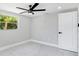 Bright bedroom with new white marble-look tile flooring, fan, and window at 208 Palmetto W Rd, Nokomis, FL 34275