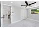 Bright bedroom with new white marble-look tile flooring, fan, and closet at 208 Palmetto W Rd, Nokomis, FL 34275