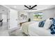 Relaxing bedroom featuring a comfortable bed, ceiling fan, and scenic outdoor view at 208 Palmetto W Rd, Nokomis, FL 34275