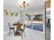 Eat-in dining area featuring new marble-look tile floor and view to sun room at 208 Palmetto W Rd, Nokomis, FL 34275
