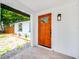 Inviting entrance with an eye-catching wood door, stylish light fixture and fresh landscaping at 208 Palmetto W Rd, Nokomis, FL 34275