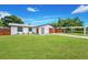Attractive home with a pristine lawn and a convenient covered parking spot at 208 Palmetto W Rd, Nokomis, FL 34275