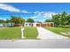 A bright, inviting home featuring a well-kept lawn and convenient carport at 208 Palmetto W Rd, Nokomis, FL 34275