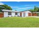 Charming home featuring a manicured lawn, a new roof, fresh paint, and mature trees at 208 Palmetto W Rd, Nokomis, FL 34275