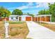 Charming single Gathering home boasts a private carport and well-maintained front yard at 208 Palmetto W Rd, Nokomis, FL 34275