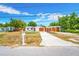 Charming single-story home with a neatly landscaped front yard and a spacious driveway leading to a covered parking area at 208 Palmetto W Rd, Nokomis, FL 34275