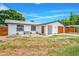 Charming single-story home with a newly installed front lawn and a spacious driveway leading to a covered parking area at 208 Palmetto W Rd, Nokomis, FL 34275