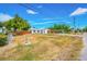 View of the exterior, showing the well-kept yard, a fire hydrant, and a side view of the charming single-story home at 208 Palmetto W Rd, Nokomis, FL 34275