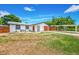 Charming single-story home with a newly installed front lawn and a spacious driveway leading to a covered parking area at 208 Palmetto W Rd, Nokomis, FL 34275