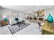 Open-concept living room filled with light, flowing into kitchen with breakfast bar for flexible living at 208 Palmetto W Rd, Nokomis, FL 34275