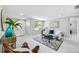 Cozy living room with white sofa, leather chairs, modern decor, and ample natural light at 208 Palmetto W Rd, Nokomis, FL 34275