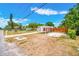 Neighborhood view showcasing the home with a carport and modern fence at 208 Palmetto W Rd, Nokomis, FL 34275