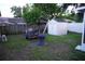 Backyard area featuring a shed, trailer, and various items with a partial view of the house at 2304 W Rio Vista Ave, Tampa, FL 33603