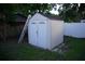 View of a storage shed in the backyard, with a ladder leaning on the side at 2304 W Rio Vista Ave, Tampa, FL 33603