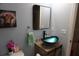 Elegant bathroom boasts unique blue glass vessel sink, modern fixtures, and thoughtful decor at 2304 W Rio Vista Ave, Tampa, FL 33603