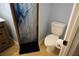 Bathroom featuring a toilet, tiled floor, and a shower with blue and white patterned curtain at 2304 W Rio Vista Ave, Tampa, FL 33603