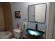 Stylish bathroom featuring a blue glass vessel sink, modern fixtures, and updated shower at 2304 W Rio Vista Ave, Tampa, FL 33603