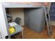 Bedroom featuring a lofted bed, built-in wardrobe, and adjacent study area at 2304 W Rio Vista Ave, Tampa, FL 33603