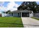 Charming single-story home featuring a well-maintained lawn and a screened front porch at 2304 W Rio Vista Ave, Tampa, FL 33603