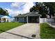 Charming single-story home featuring a well-maintained lawn and a screened front porch at 2304 W Rio Vista Ave, Tampa, FL 33603