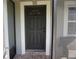 The covered front porch leads to a solid dark front door, framed with white trim at 2304 W Rio Vista Ave, Tampa, FL 33603