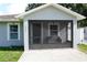 Inviting screened front porch with seating and tiled floor at 2304 W Rio Vista Ave, Tampa, FL 33603