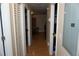 Functional hallway featuring laminate floors, closet doors, and access to various areas of the home at 2304 W Rio Vista Ave, Tampa, FL 33603