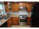 Stylish kitchen showcasing wood cabinetry, stainless steel appliances, and complementary countertops at 2304 W Rio Vista Ave, Tampa, FL 33603