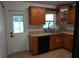 Efficient kitchen featuring wood cabinetry, stainless steel sink, and modern appliances at 2304 W Rio Vista Ave, Tampa, FL 33603