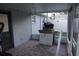 View of the screened-in patio with tile flooring, grill, and access to the backyard at 2304 W Rio Vista Ave, Tampa, FL 33603