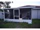 View of screened-in patio with outdoor furniture and equipment, extending the living space at 2304 W Rio Vista Ave, Tampa, FL 33603