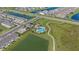 Aerial view of a community pool, clubhouse, walking path, and neighborhood at 2492 Overfalls Pl, Wesley Chapel, FL 33543
